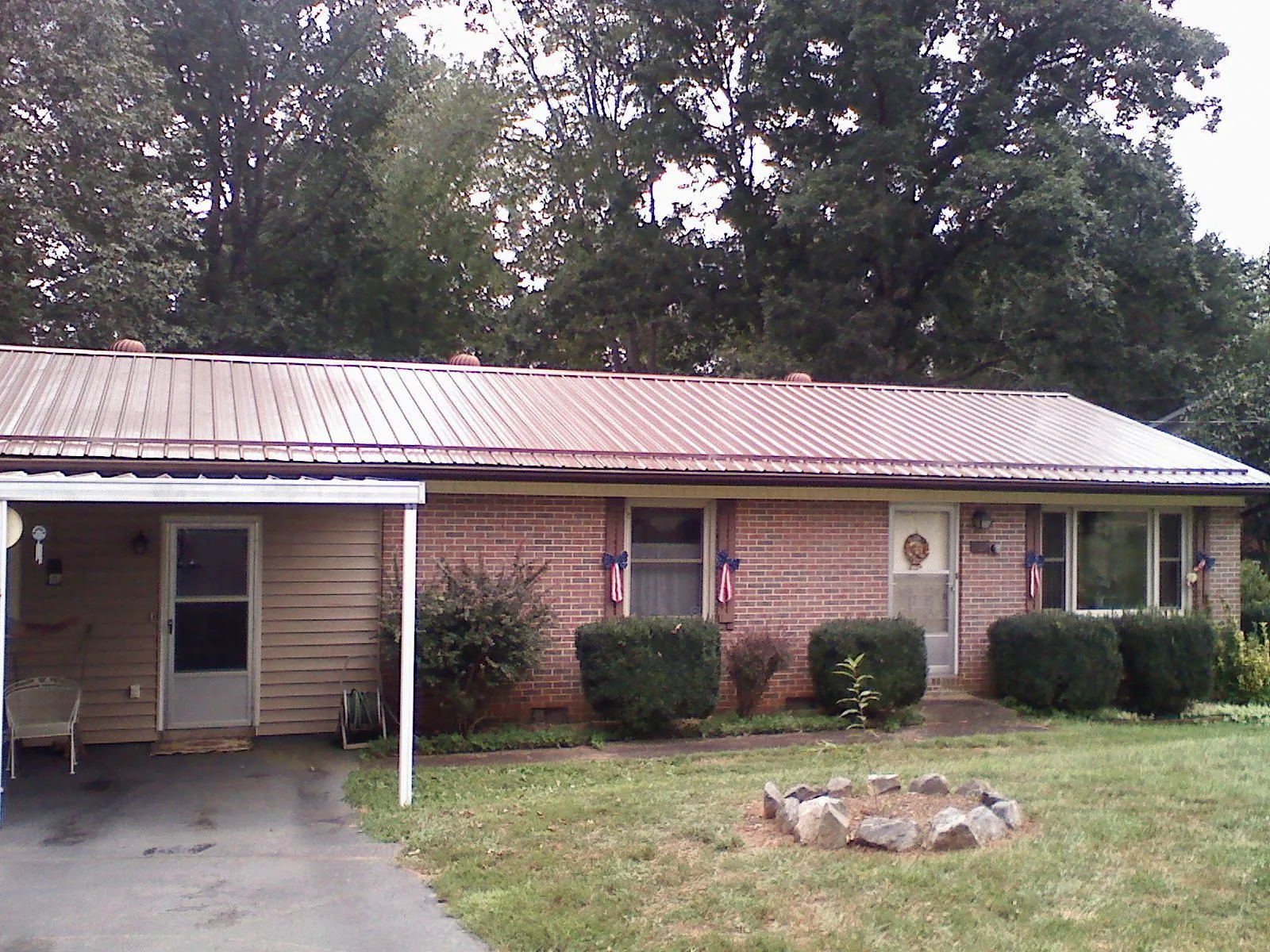 Bronze metal roof and carport on a brick ranch home — Roof Repair work by our crew in Edmonds